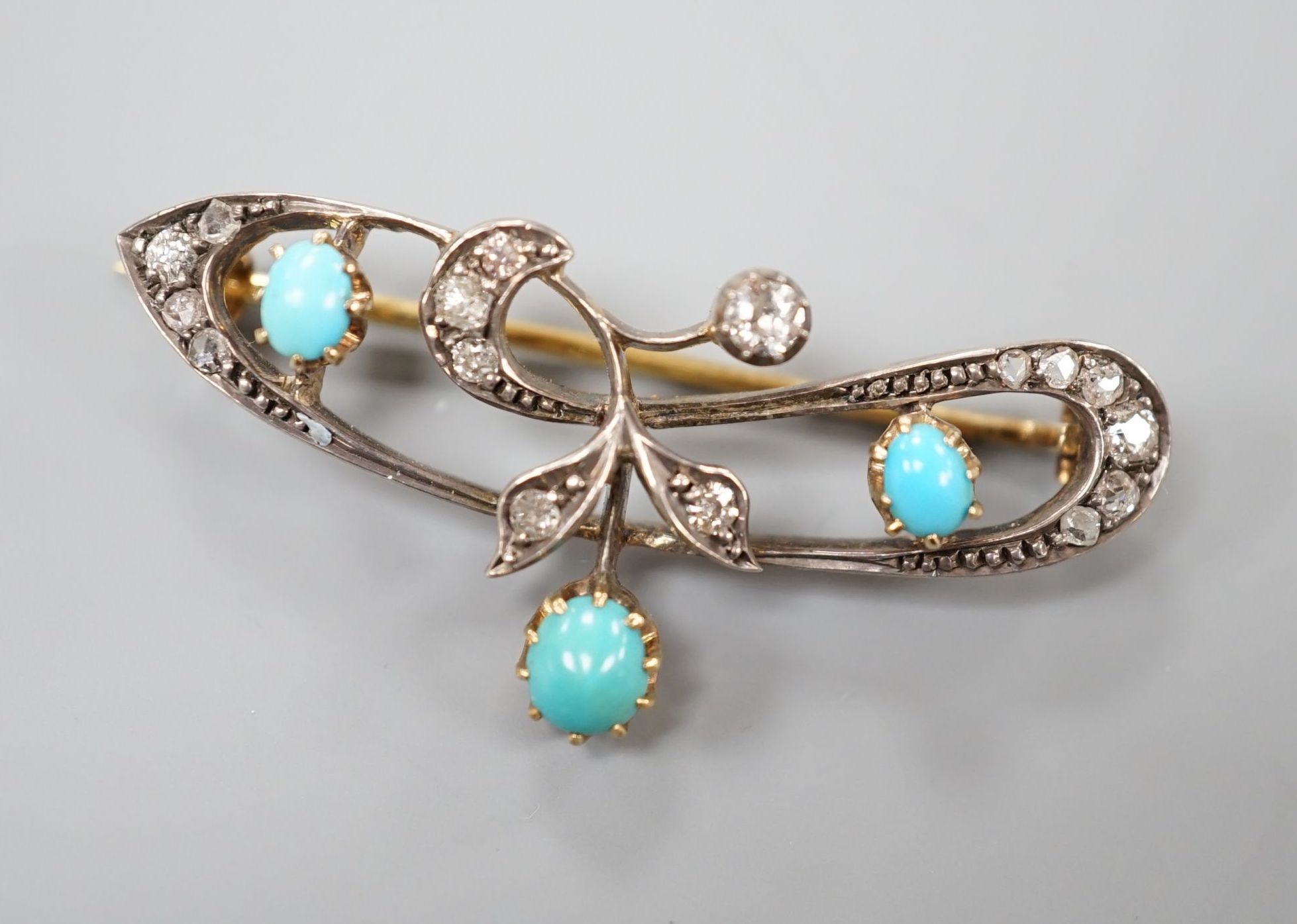 A late Victorian yellow metal, turquoise and diamond set openwork scroll brooch, 40mm, gross weight 5.5 grams.